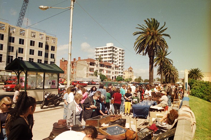 People interacting with stallholders at the St Kilda Esplanade Market circa 1970